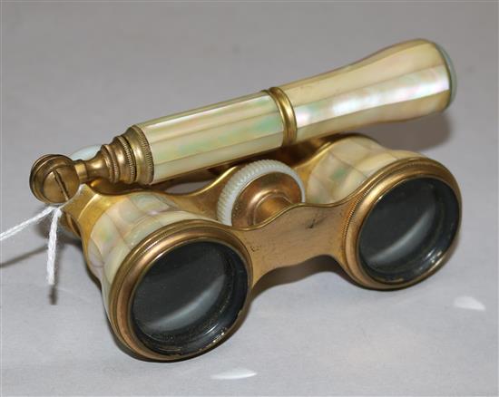 A pair of gilt metal and mother of pearl opera glasses, L. Petit, Paris, with folding handle and velvet bag